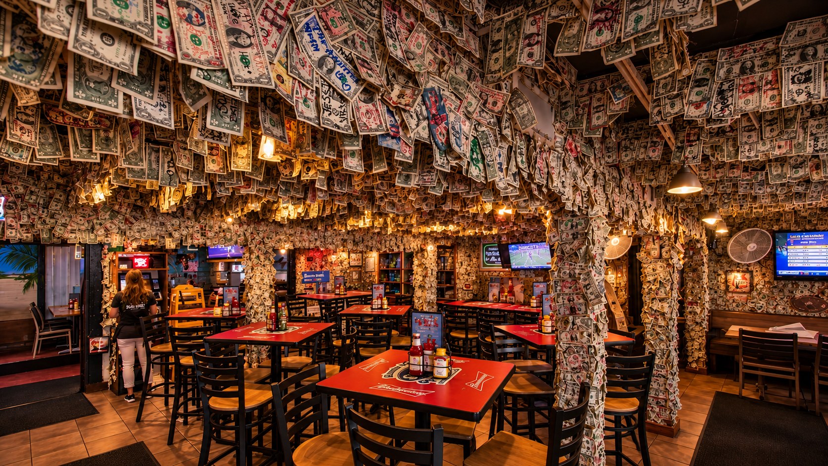 The dining room of the Siesta Key Oyster Bar, every ceiling, wall and post covered in signed dollar bills