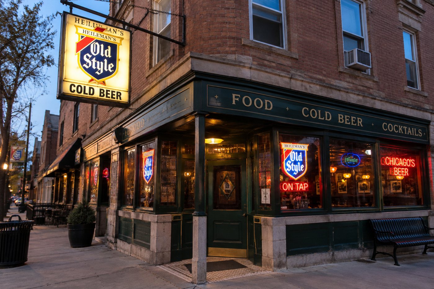 A brick corner tavern at dusk under a lit Old Style sign, Food, Cold Beer and Cocktails lettered over the windows